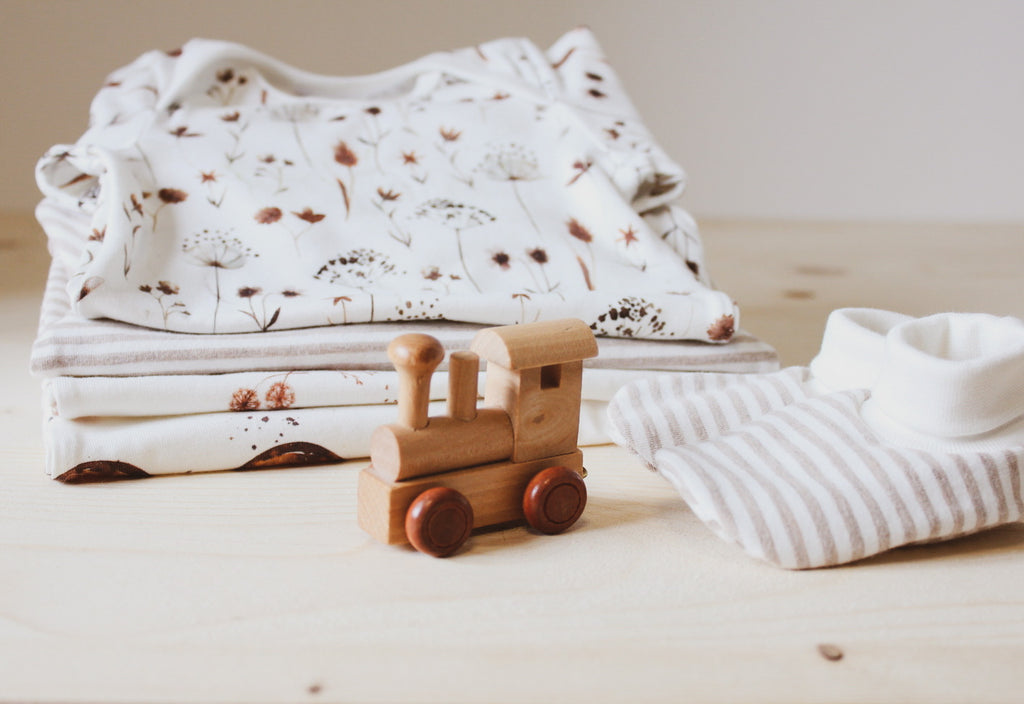 Wooden train toy, booties and baby clothes